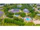 Stunning aerial view of community amenities including a pool, tennis courts, clubhouse, and mature trees at 5426 Astor St, Leesburg, FL 34748
