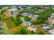 Breathtaking aerial view of the community showcasing the pool, tennis courts, lake, and clubhouse at 5426 Astor St, Leesburg, FL 34748