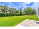 Expansive backyard with lush green lawn and mature landscaping and privacy hedges at 5426 Astor St, Leesburg, FL 34748