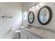 Bright bathroom featuring dual mirrors and vanity with quartz countertops at 5426 Astor St, Leesburg, FL 34748