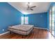 Bedroom featuring wood floors, access to porch and natural light at 5426 Astor St, Leesburg, FL 34748