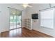 Bedroom features wood floors and access to a screened-in porch at 5426 Astor St, Leesburg, FL 34748