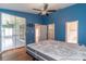 Bedroom featuring wood floors, access to porch, and multiple entries at 5426 Astor St, Leesburg, FL 34748