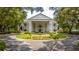 Stately clubhouse featuring a circular driveway, elegant landscaping, and classic architectural design at 5426 Astor St, Leesburg, FL 34748