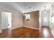 Dining room featuring wood floors, neutral paint, and views of the kitchen at 5426 Astor St, Leesburg, FL 34748