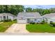 Charming single-story home with a well-manicured lawn and a concrete driveway at 5426 Astor St, Leesburg, FL 34748
