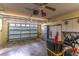 Spacious garage with ample storage cabinets, ceiling fan, and overhead lighting at 5426 Astor St, Leesburg, FL 34748