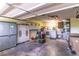 Well-organized garage space with storage cabinets, washer, dryer and utility sink at 5426 Astor St, Leesburg, FL 34748