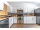 Beautiful kitchen featuring white cabinets, granite countertops, and stainless steel appliances at 5426 Astor St, Leesburg, FL 34748