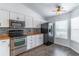 Modern kitchen featuring white cabinets, stainless steel appliances, and a bright window at 5426 Astor St, Leesburg, FL 34748
