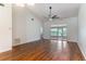 Bright living room with wood floors, a modern ceiling fan, and sliding doors to lanai at 5426 Astor St, Leesburg, FL 34748