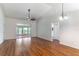 Spacious living room with wood floors, fan and sliding doors to lanai at 5426 Astor St, Leesburg, FL 34748