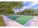 Scenic shuffleboard courts bordered by lush greenery, perfect for friendly competition at 5426 Astor St, Leesburg, FL 34748