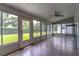 Bright sunroom features multiple windows providing tons of natural light and tile flooring at 5426 Astor St, Leesburg, FL 34748