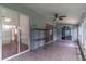 This sunroom has tile floors, a ceiling fan, and sliding glass doors leading into other rooms at 5426 Astor St, Leesburg, FL 34748