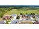 Aerial view of homes along a street bordering an open space with lake in the distance at 5577 Sycamore Canyon Dr, Kissimmee, FL 34758
