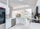 Bright kitchen features white cabinets, stainless steel appliances, and a mosaic backsplash, with an open view to the living area at 5577 Sycamore Canyon Dr, Kissimmee, FL 34758