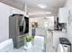 Bright and airy kitchen with stainless steel appliances, white cabinets, and a modern tile backsplash at 5577 Sycamore Canyon Dr, Kissimmee, FL 34758