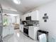 Well-lit kitchen with white cabinets, stainless steel appliances, and an open view to the living area at 5577 Sycamore Canyon Dr, Kissimmee, FL 34758