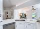 Bright kitchen features an island with white countertops, stainless steel appliances, and open view to living area at 5577 Sycamore Canyon Dr, Kissimmee, FL 34758