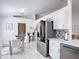 Modern kitchen featuring stainless steel appliances, white cabinets, quartz countertops, and a breakfast nook at 5577 Sycamore Canyon Dr, Kissimmee, FL 34758