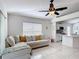 Bright living room showcases an open floor plan to the kitchen with comfortable seating and tile floors at 5577 Sycamore Canyon Dr, Kissimmee, FL 34758
