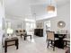 Spacious living room with white tile floors, comfortable seating, and an open layout to the dining area at 5577 Sycamore Canyon Dr, Kissimmee, FL 34758