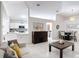 Living room and kitchen featuring an open layout, with white cabinets and a view of the dining space at 5577 Sycamore Canyon Dr, Kissimmee, FL 34758