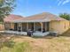 View of screened-in back porch with outdoor seating and BBQ grill at 5577 Sycamore Canyon Dr, Kissimmee, FL 34758