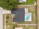 Birds-eye view of a home showcasing a pristine pool, screened-in lanai, and lush surroundings at 5642 Chukar Dr, Orlando, FL 32810