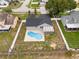 A home from above showing off a pristine pool and a screened-in lanai within its fenced yard at 5642 Chukar Dr, Orlando, FL 32810