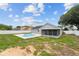 Lovely backyard featuring an inviting kidney-shaped pool and a screened-in lanai for outdoor enjoyment at 5642 Chukar Dr, Orlando, FL 32810