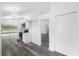 Updated kitchen showcasing white cabinets, gray floors, stainless appliances, and modern lighting at 5642 Chukar Dr, Orlando, FL 32810