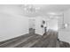 Open-concept living area showcasing gray wood-look flooring, white walls, and modern lighting fixtures at 5642 Chukar Dr, Orlando, FL 32810
