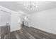 Open-concept living area showcasing gray wood-look flooring, white walls, and modern lighting fixtures at 5642 Chukar Dr, Orlando, FL 32810
