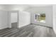Bright, open room showcasing light gray wood flooring, neutral walls, and open doorway at 5642 Chukar Dr, Orlando, FL 32810