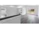 Open living room featuring light gray wood floors, neutral walls, and large windows at 5642 Chukar Dr, Orlando, FL 32810