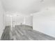Bright and open living area showcasing light gray wood flooring, neutral walls, and natural lighting at 5642 Chukar Dr, Orlando, FL 32810