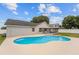 The pool features a sun shelf and is located near the home's screened-in patio at 5642 Chukar Dr, Orlando, FL 32810