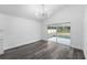 Sunroom displaying gray wood-look flooring, sliding glass doors, and backyard views at 5642 Chukar Dr, Orlando, FL 32810