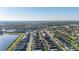 Neighborhood aerial view showcases a residential community with a nearby lake at 7184 Oakmoss Loop, Davenport, FL 33837