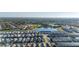 Beautiful aerial view of a community with a lake, green spaces, and various single-Gathering houses and town houses at 7184 Oakmoss Loop, Davenport, FL 33837
