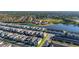 Beautiful aerial view of a community with a lake, green spaces, and various single-Gathering houses and town houses at 7184 Oakmoss Loop, Davenport, FL 33837