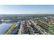 Real estate aerial view showcases the neighborhood with nearby community lake at 7184 Oakmoss Loop, Davenport, FL 33837