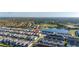 Beautiful aerial view of a community with a lake, green spaces, and various single-Gathering houses and town houses at 7184 Oakmoss Loop, Davenport, FL 33837