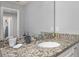Bathroom featuring granite vanity and large mirror at 7184 Oakmoss Loop, Davenport, FL 33837