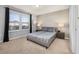 Bedroom with a large window, modern decor, and a comfortable, neutral color palette at 7184 Oakmoss Loop, Davenport, FL 33837