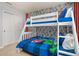 bedroom featuring bunk beds, comic wallpaper, and carpet at 7184 Oakmoss Loop, Davenport, FL 33837