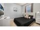 Modern bedroom with neutral decor, a dark comforter, and a mounted television at 7184 Oakmoss Loop, Davenport, FL 33837