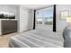 Brightly lit bedroom with large double window and modern decor at 7184 Oakmoss Loop, Davenport, FL 33837